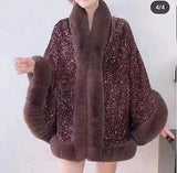Luxurious and cozy—this fur-trimmed sequin cape