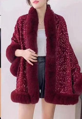 Luxurious and cozy—this fur-trimmed sequin cape